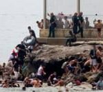 Hundreds of migrants swim from Morocco to Spanish enclave of Ceuta