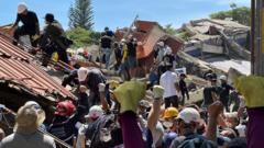 Anguish of Colombian brother at rubble of building being searched for earthquake survivors